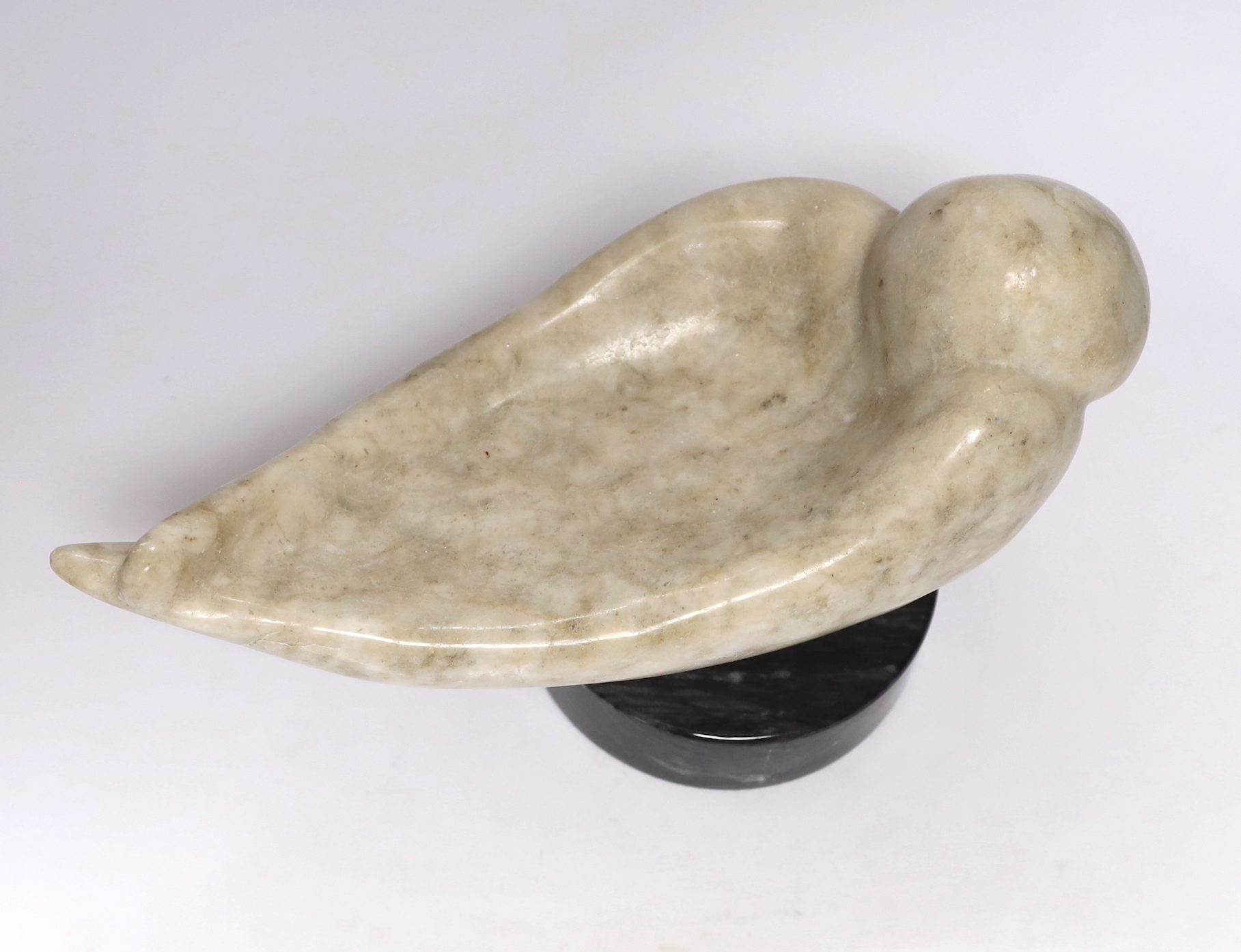 A Shona stone carving of a bird, possibly by Ignatius Zhakawayi, on a marble base, 35cm long